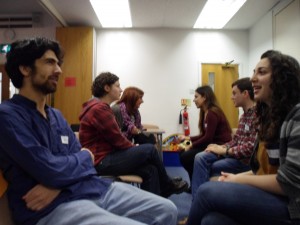 Rainbow Jews volunteers seated, doing role play